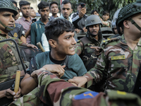 Bangladesh Armed Force personnel arrest picketers amid a clash in Dhaka, Bangladesh, on November 20, 2024. (