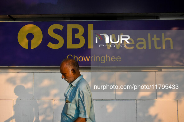 A man walks past a branch of State Bank of India Wealth Management in Kolkata, India, on October 20, 2024. 