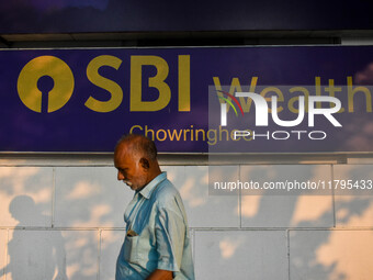 A man walks past a branch of State Bank of India Wealth Management in Kolkata, India, on October 20, 2024. (