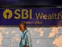 A man walks past a branch of State Bank of India Wealth Management in Kolkata, India, on October 20, 2024. (