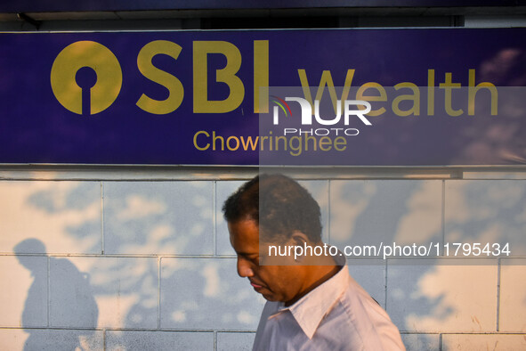 A man walks past a branch of State Bank of India Wealth Management in Kolkata, India, on October 20, 2024. 