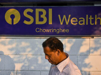 A man walks past a branch of State Bank of India Wealth Management in Kolkata, India, on October 20, 2024. (