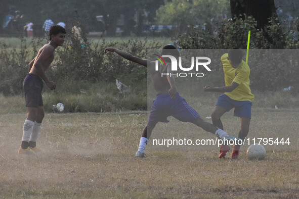 Boys practice football at a ground in Kolkata, India, on October 20, 2024, during a winter afternoon. 