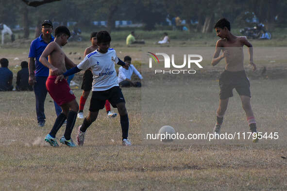 Boys practice football at a ground in Kolkata, India, on October 20, 2024, during a winter afternoon. 