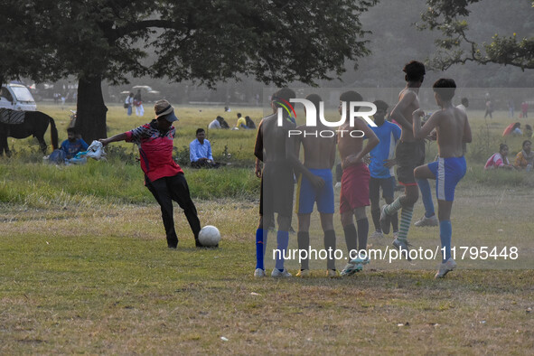 Boys practice football at a ground in Kolkata, India, on October 20, 2024, during a winter afternoon. 