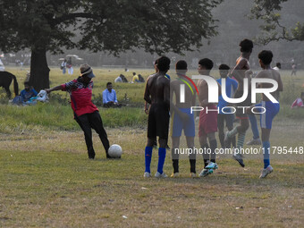 Boys practice football at a ground in Kolkata, India, on October 20, 2024, during a winter afternoon. (