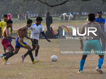 Boys practice football at a ground in Kolkata, India, on October 20, 2024, during a winter afternoon. (