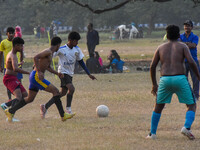 Boys practice football at a ground in Kolkata, India, on October 20, 2024, during a winter afternoon. (