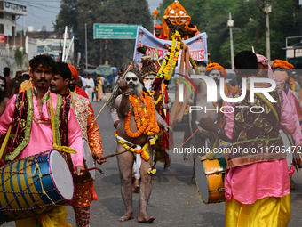 Indian Sadhus (holy men) of Shri Panch Dashnam Juna Akhara participate in a religious procession during the grand Nagar Pravesh ceremony for...