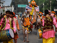 Indian Sadhus (holy men) of Shri Panch Dashnam Juna Akhara participate in a religious procession during the grand Nagar Pravesh ceremony for...