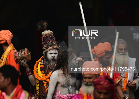 Indian Sadhus (holy men) of Shri Panch Dashnam Juna Akhara participate in a religious procession during the grand Nagar Pravesh ceremony for...