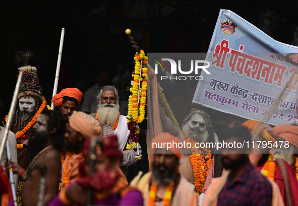 Indian Sadhus (holy men) of Shri Panch Dashnam Juna Akhara participate in a religious procession during the grand Nagar Pravesh ceremony for...