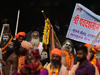 Indian Sadhus (holy men) of Shri Panch Dashnam Juna Akhara participate in a religious procession during the grand Nagar Pravesh ceremony for...