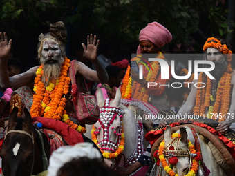 Indian Sadhus (holy men) of Shri Panch Dashnam Juna Akhara participate in a religious procession during the grand Nagar Pravesh ceremony for...