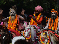 Indian Sadhus (holy men) of Shri Panch Dashnam Juna Akhara participate in a religious procession during the grand Nagar Pravesh ceremony for...