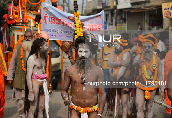 Indian Sadhus (holy men) of Shri Panch Dashnam Juna Akhara participate in a religious procession during the grand Nagar Pravesh ceremony for...