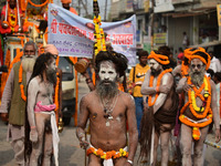 Indian Sadhus (holy men) of Shri Panch Dashnam Juna Akhara participate in a religious procession during the grand Nagar Pravesh ceremony for...