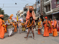 Indian Sadhus (holy men) of Shri Panch Dashnam Juna Akhara participate in a religious procession during the grand Nagar Pravesh ceremony for...