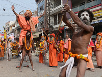 Indian Sadhus (holy men) of Shri Panch Dashnam Juna Akhara participate in a religious procession during the grand Nagar Pravesh ceremony for...