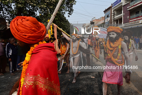 Indian Sadhus (holy men) of Shri Panch Dashnam Juna Akhara participate in a religious procession during the grand Nagar Pravesh ceremony for...