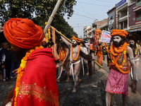 Indian Sadhus (holy men) of Shri Panch Dashnam Juna Akhara participate in a religious procession during the grand Nagar Pravesh ceremony for...