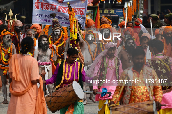 Indian Sadhus (holy men) of Shri Panch Dashnam Juna Akhara participate in a religious procession during the grand Nagar Pravesh ceremony for...