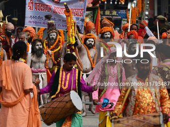 Indian Sadhus (holy men) of Shri Panch Dashnam Juna Akhara participate in a religious procession during the grand Nagar Pravesh ceremony for...