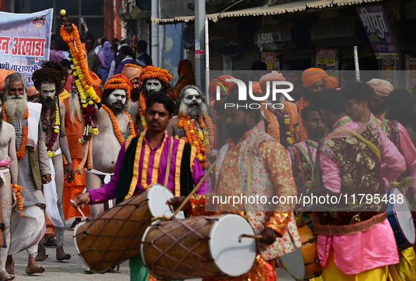 Indian Sadhus (holy men) of Shri Panch Dashnam Juna Akhara participate in a religious procession during the grand Nagar Pravesh ceremony for...