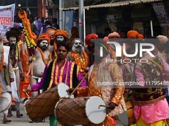 Indian Sadhus (holy men) of Shri Panch Dashnam Juna Akhara participate in a religious procession during the grand Nagar Pravesh ceremony for...