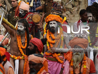 Indian Sadhus (holy men) of Shri Panch Dashnam Juna Akhara participate in a religious procession during the grand Nagar Pravesh ceremony for...