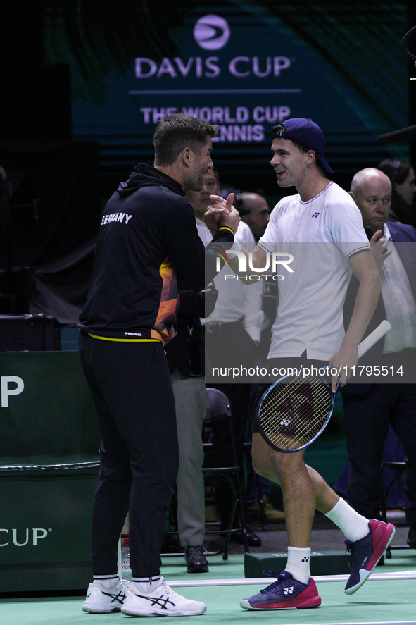 MALAGA, SPAIN - NOVEMBER 20: Daniel Altmaier of Team Germany celebrates the victory with his Captain after his singles match against Gabriel...