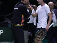 MALAGA, SPAIN - NOVEMBER 20: Daniel Altmaier of Team Germany celebrates the victory with his Captain after his singles match against Gabriel...