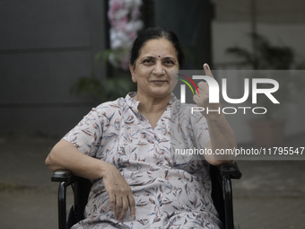 An Indian voter poses with her inked finger after casting her ballot during the Maharashtra state assembly elections at a polling booth in M...