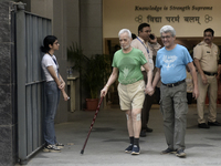 Indian voters come out after casting their ballots during the Maharashtra state assembly elections at a polling booth in Mumbai, India, on N...