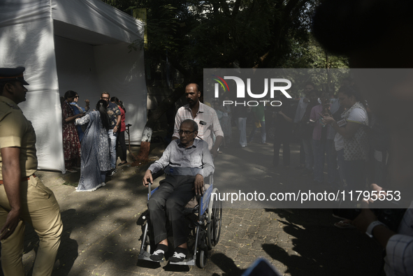 A man in a wheelchair casts his ballot to vote during the Maharashtra state assembly elections at a polling booth in Mumbai, India, on Novem...