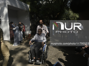 A man in a wheelchair casts his ballot to vote during the Maharashtra state assembly elections at a polling booth in Mumbai, India, on Novem...