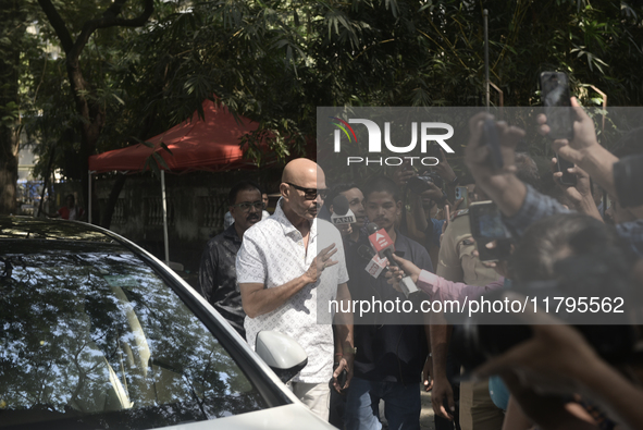 Rakesh Roshan, Indian film producer and director, enters a polling booth to cast his ballot during the Maharashtra state assembly elections...