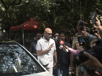 Rakesh Roshan, Indian film producer and director, enters a polling booth to cast his ballot during the Maharashtra state assembly elections...