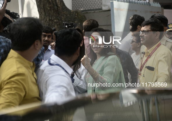 Hema Malini, an Indian actress, film director, producer, and politician, poses with her inked fingers after casting her ballot to vote durin...