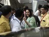 Hema Malini, an Indian actress, film director, producer, and politician, poses with her inked fingers after casting her ballot to vote durin...