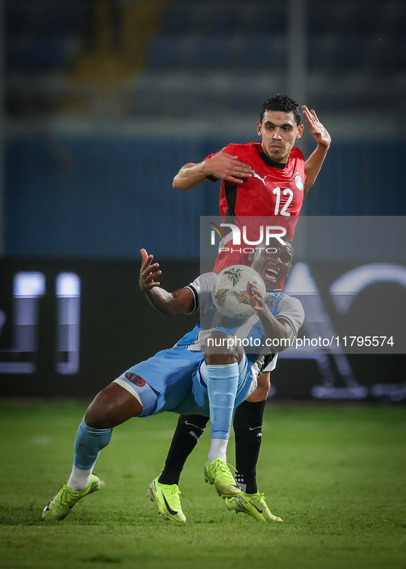 Mohamed Hamdi of the Egypt team battles for possession with Tumisang Orebonye of the Botswana team during the Africa Cup of Nations Qualifie...