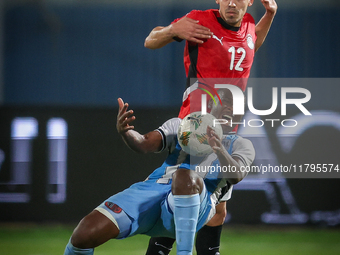 Mohamed Hamdi of the Egypt team battles for possession with Tumisang Orebonye of the Botswana team during the Africa Cup of Nations Qualifie...