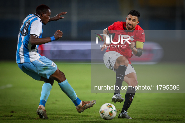 Mahmoud Trezeguet of the Egypt team battles for possession with Lebogang Ditsele of the Botswana team during the Africa Cup of Nations Quali...