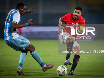 Mahmoud Trezeguet of the Egypt team battles for possession with Lebogang Ditsele of the Botswana team during the Africa Cup of Nations Quali...