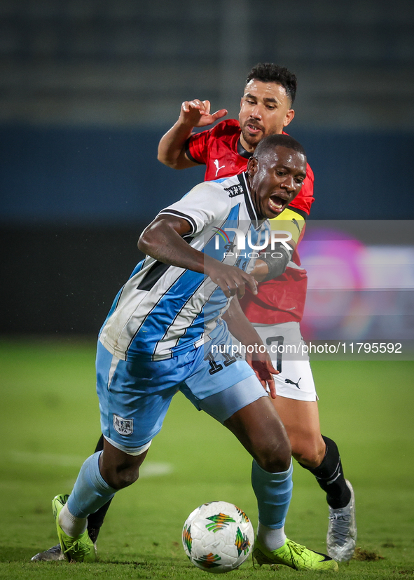 Mahmoud Trezeguet of the Egypt team battles for possession with Tumisang Orebonye of the Botswana team during the Africa Cup of Nations Qual...