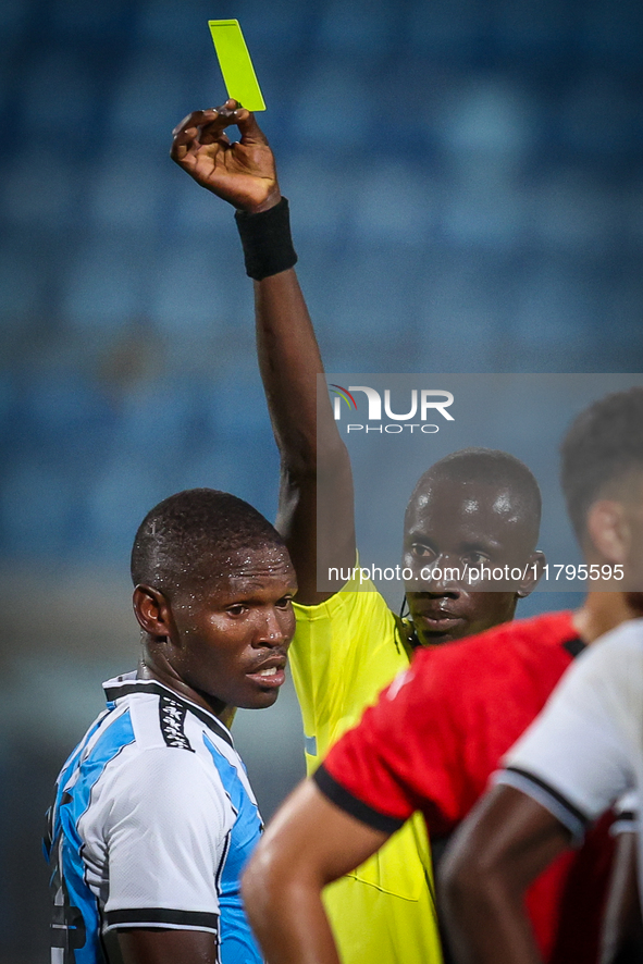 Referee Abdallah Jammeh gives a yellow card to number 14, Godiraone Modingwane of the Botswana team, during the Africa Cup of Nations Qualif...