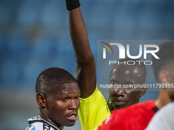 Referee Abdallah Jammeh gives a yellow card to number 14, Godiraone Modingwane of the Botswana team, during the Africa Cup of Nations Qualif...