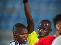 Referee Abdallah Jammeh gives a yellow card to number 14, Godiraone Modingwane of the Botswana team, during the Africa Cup of Nations Qualif...