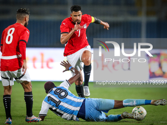 Mahmoud Trezeguet of the Egypt team battles for possession with Lebogang Ditsele of the Botswana team during the Africa Cup of Nations Quali...