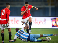 Mahmoud Trezeguet of the Egypt team battles for possession with Lebogang Ditsele of the Botswana team during the Africa Cup of Nations Quali...